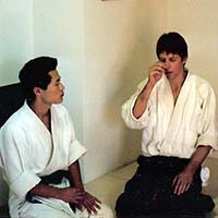 Koji and Shihan Brian Workman -scratching nose - chatting in dojo